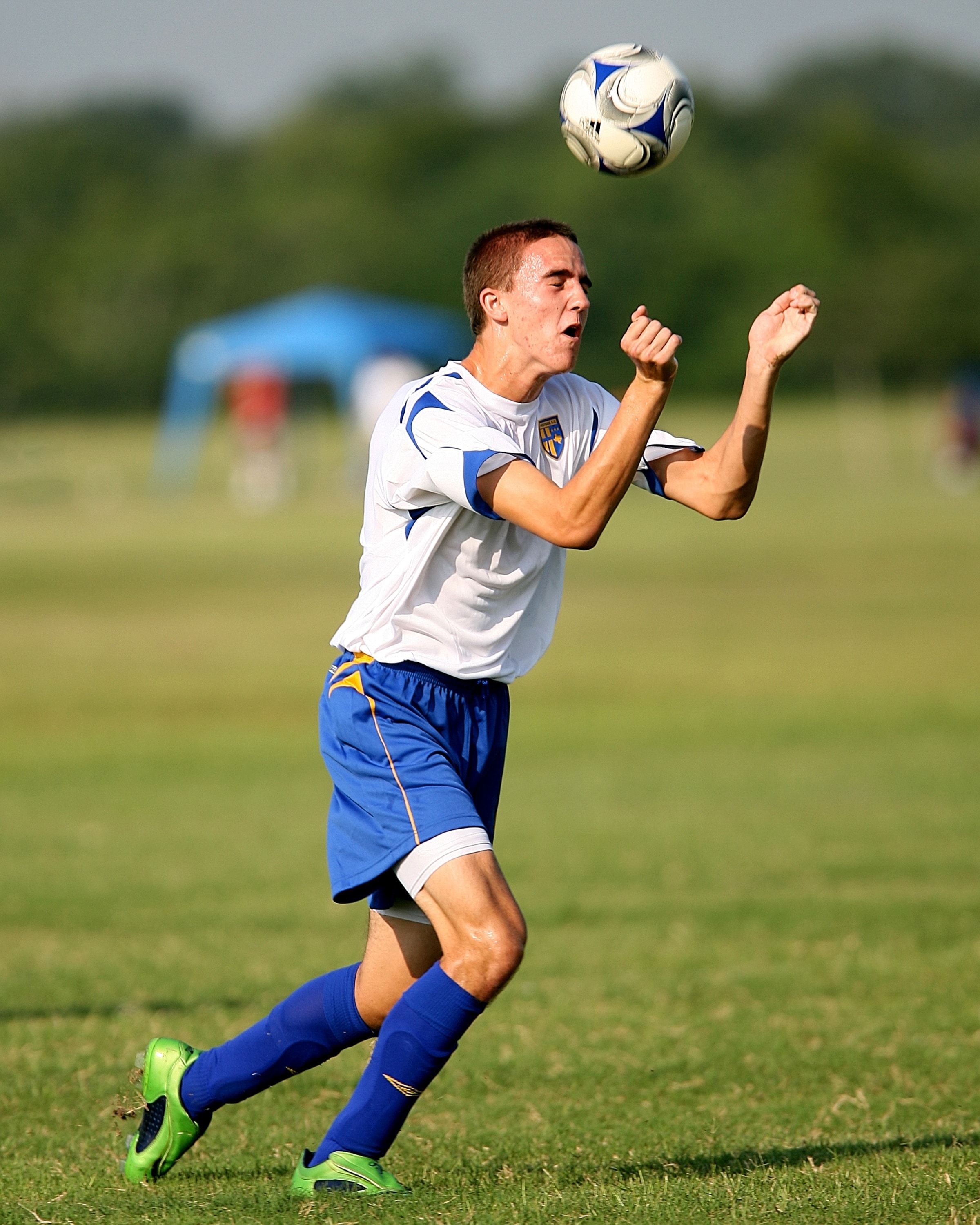 men\u0026#39;s white and blue crew neck t shirt blue shorts blue shin guards and green soccer cleats ...