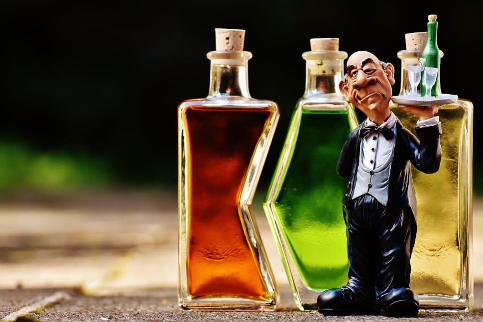 male waiter figurine and 3 glass bottles free image | Peakpx