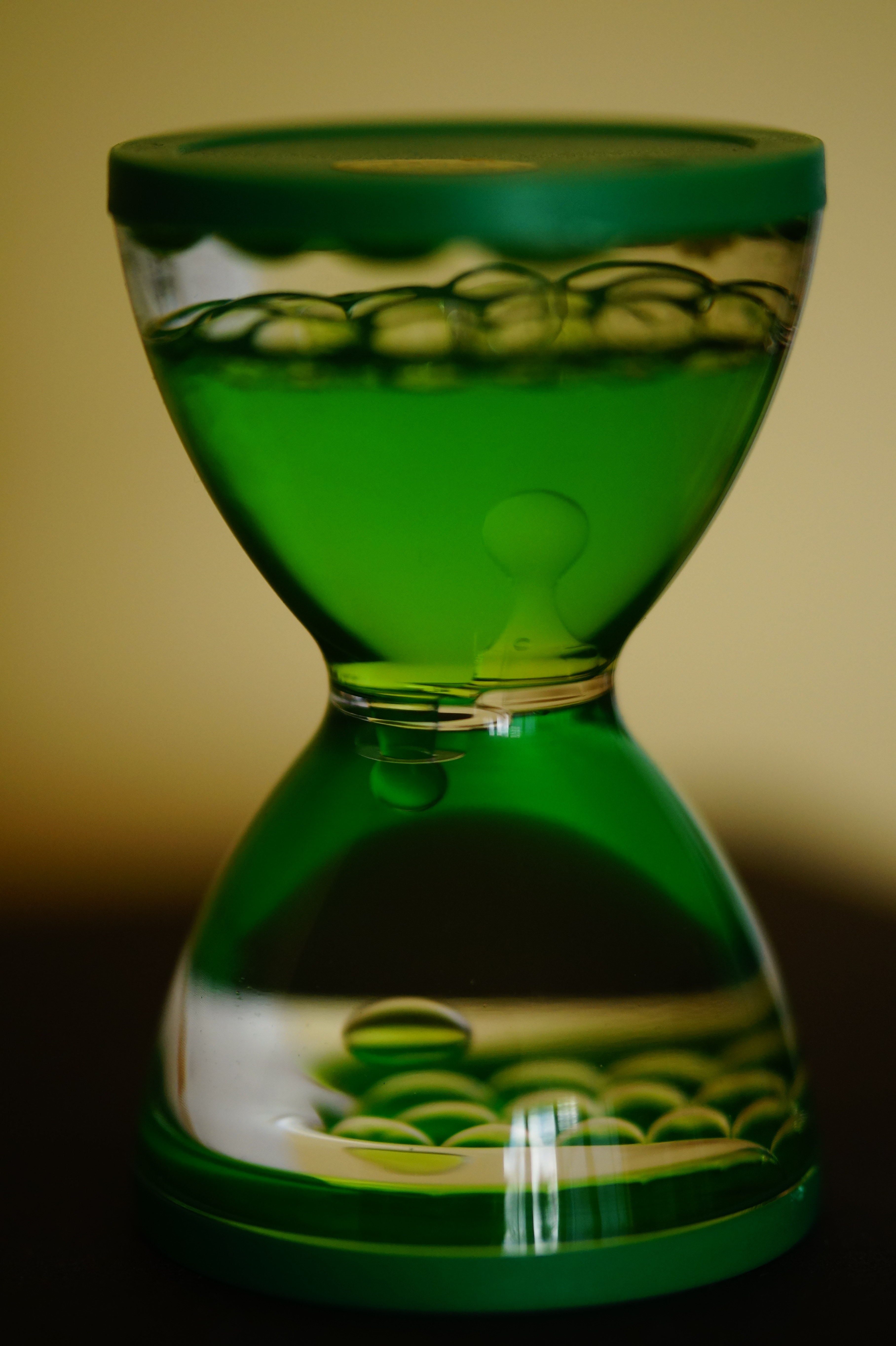 green tinted hourglass design ornament