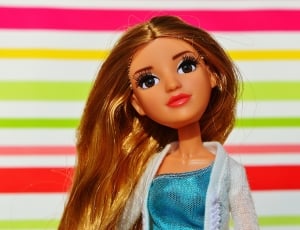 blond haired doll wearing blue and white dress thumbnail