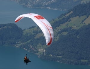 man in red suit paragliding thumbnail