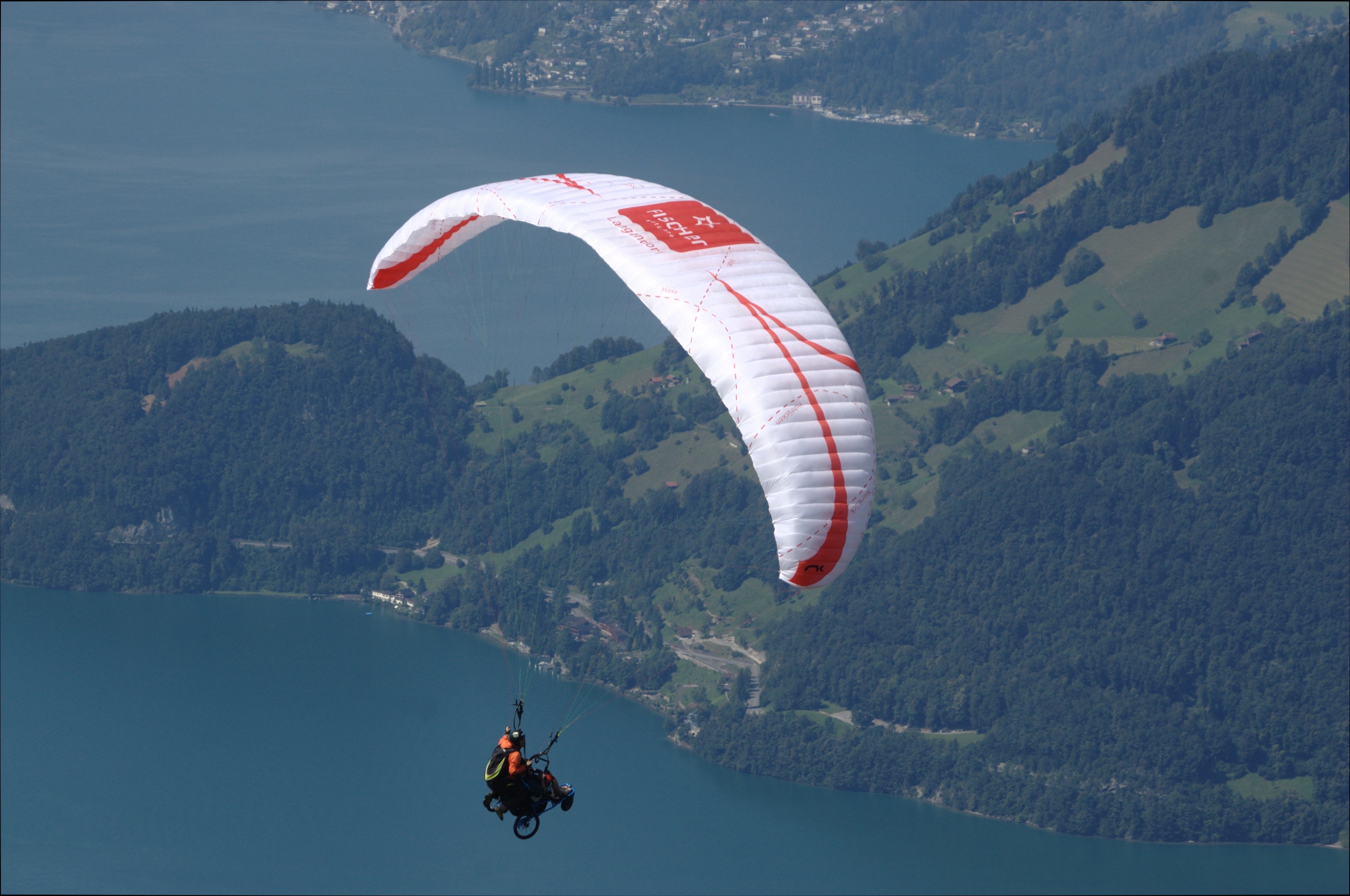 man in red suit paragliding