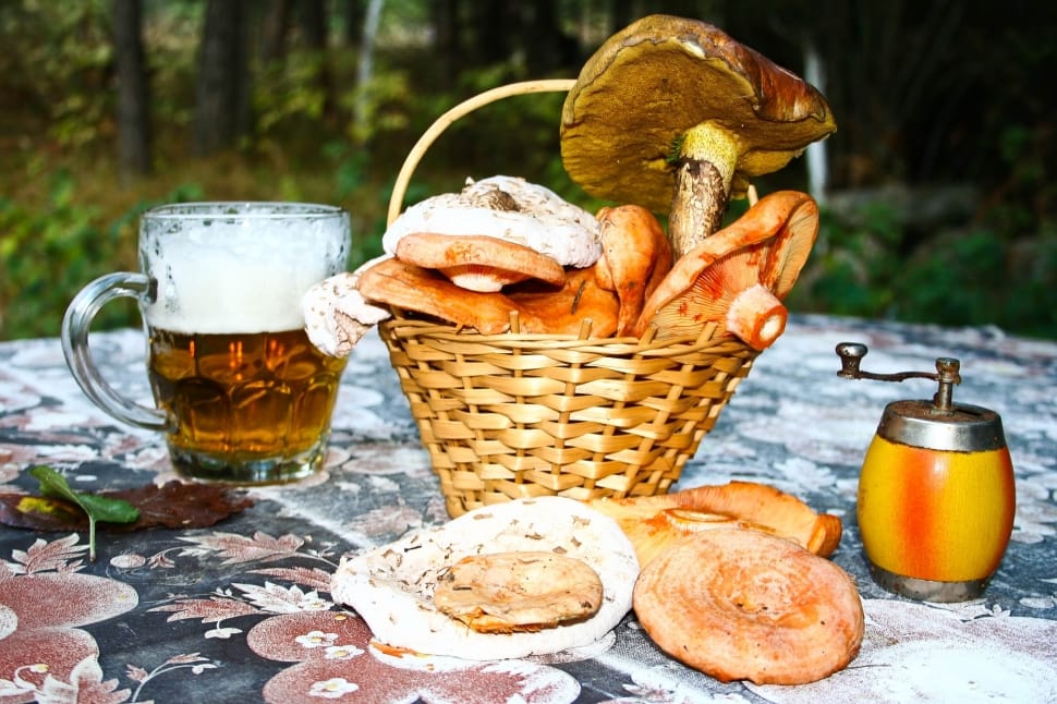 baked bread, brown wicker picnic basket and clear glass beer mug preview