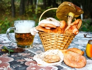 baked bread, brown wicker picnic basket and clear glass beer mug thumbnail