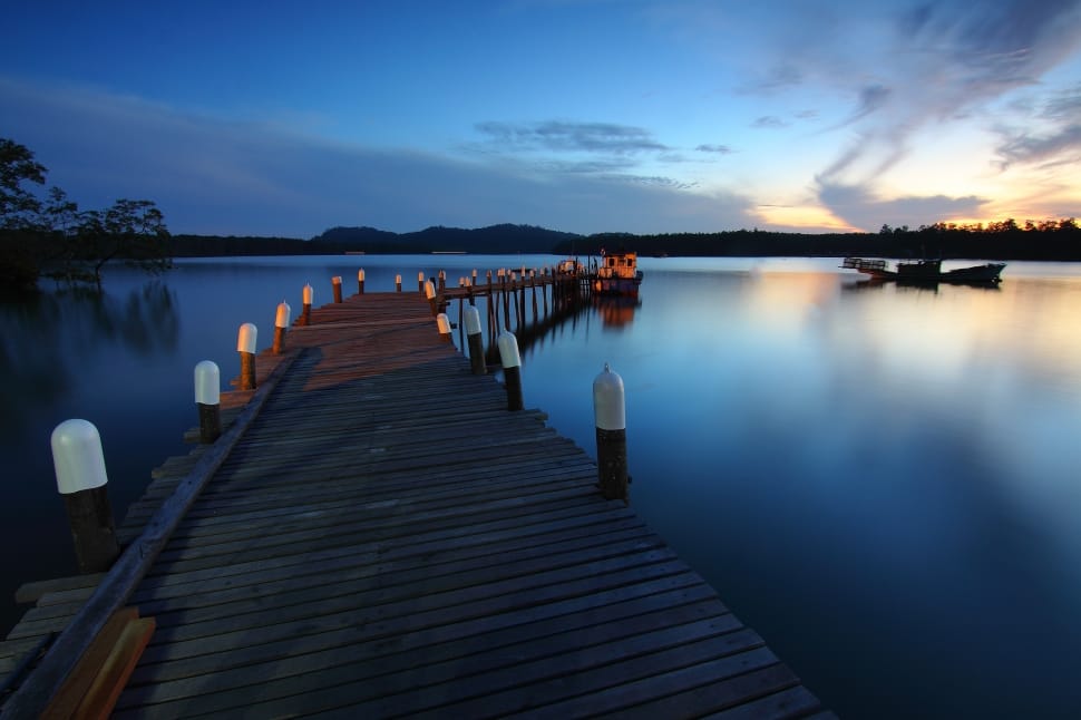 brown wooden dock under blue sky during sunset preview