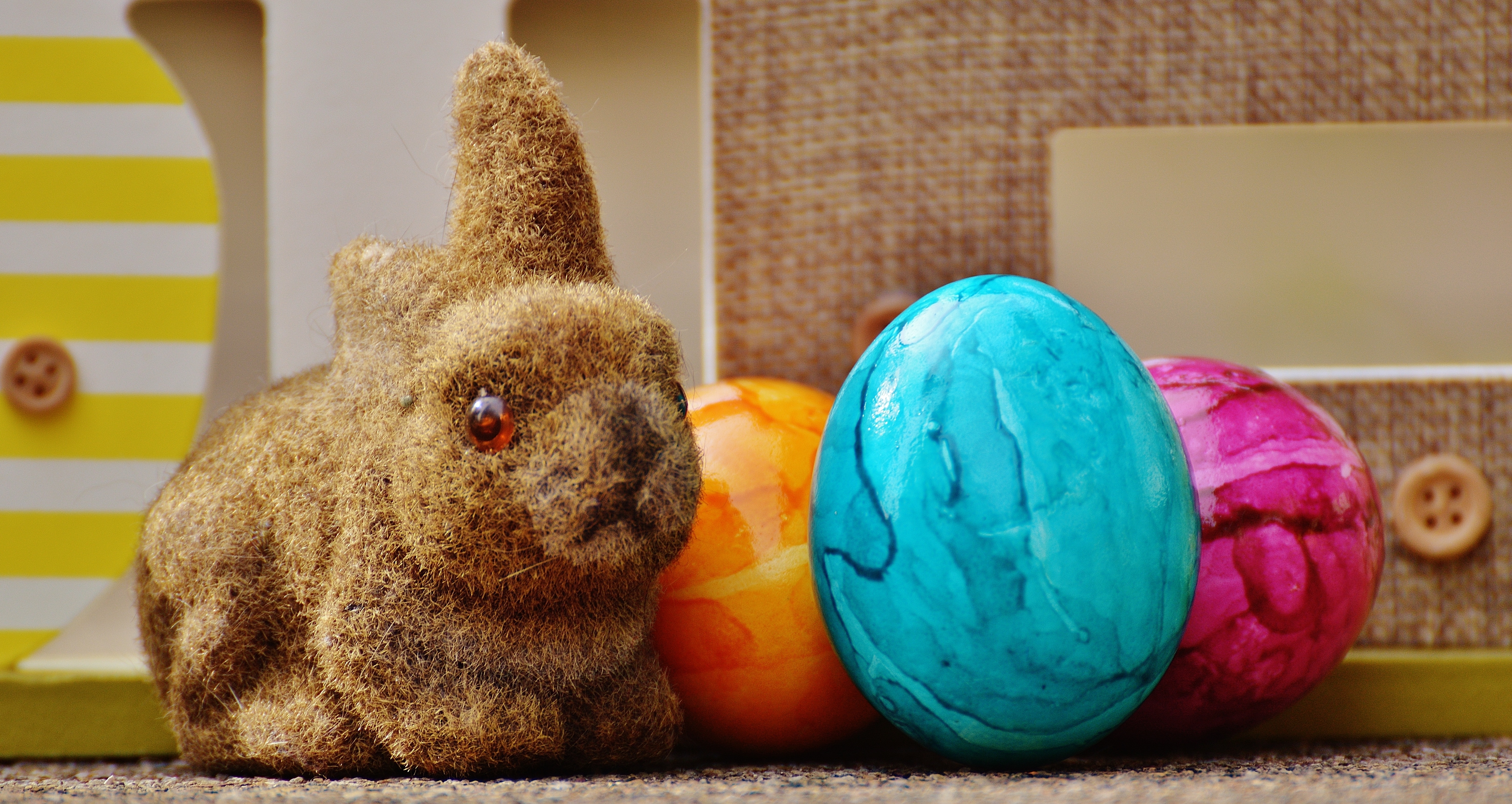 brown rabbit plush toy and three faberge eggs