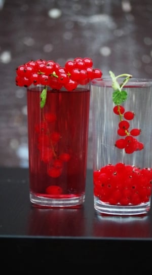 red round fruits in side clear drinking glass with liquids inside thumbnail