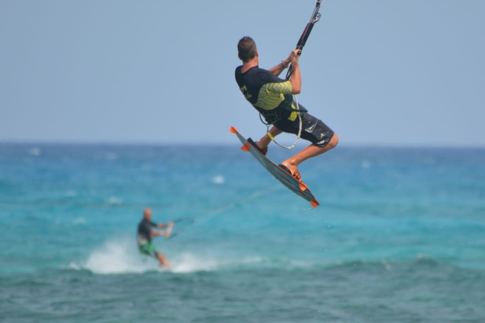 selective focus photo of man windsurfing on beach preview
