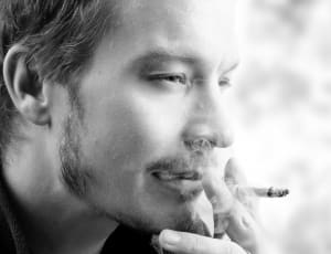 black and white of man smoking photo thumbnail