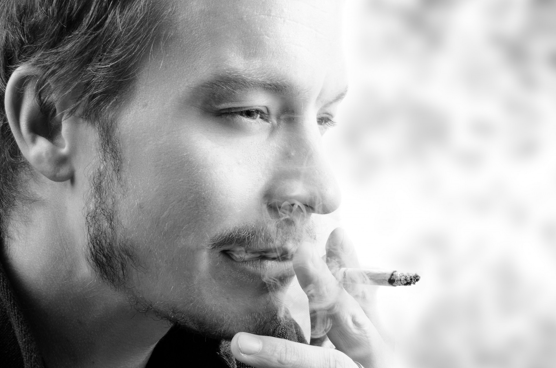 black and white of man smoking photo