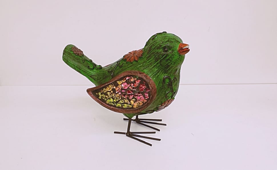 green, red and yellow bird ornament preview