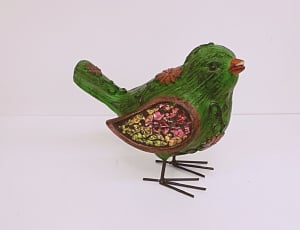 green, red and yellow bird ornament thumbnail