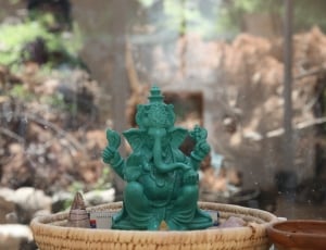 teal Ganesha figurine close up photo thumbnail