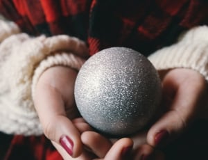 person holding gray glittered ball thumbnail