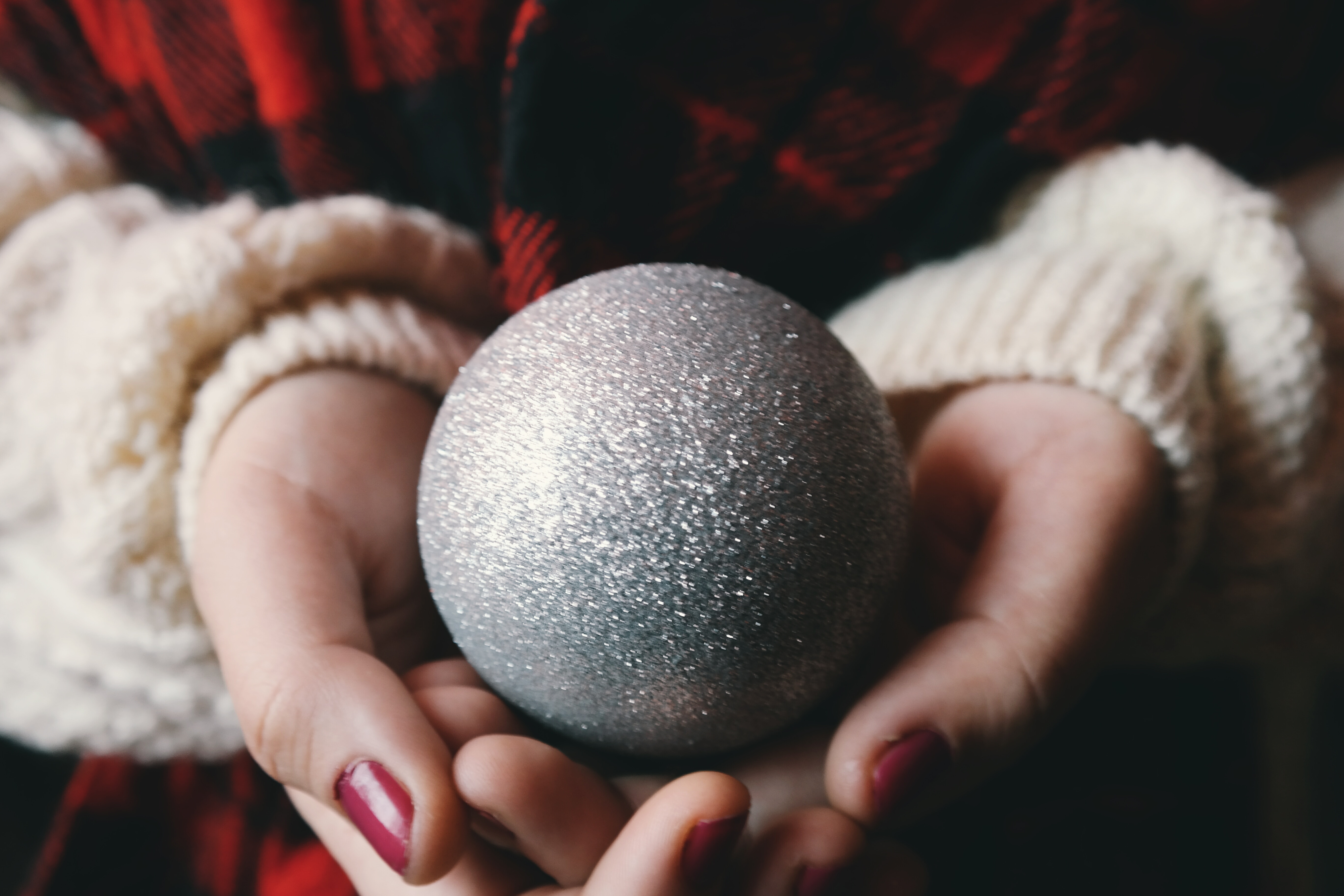 person holding gray glittered ball