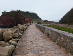 concrete wall and pathway along sea side thumbnail