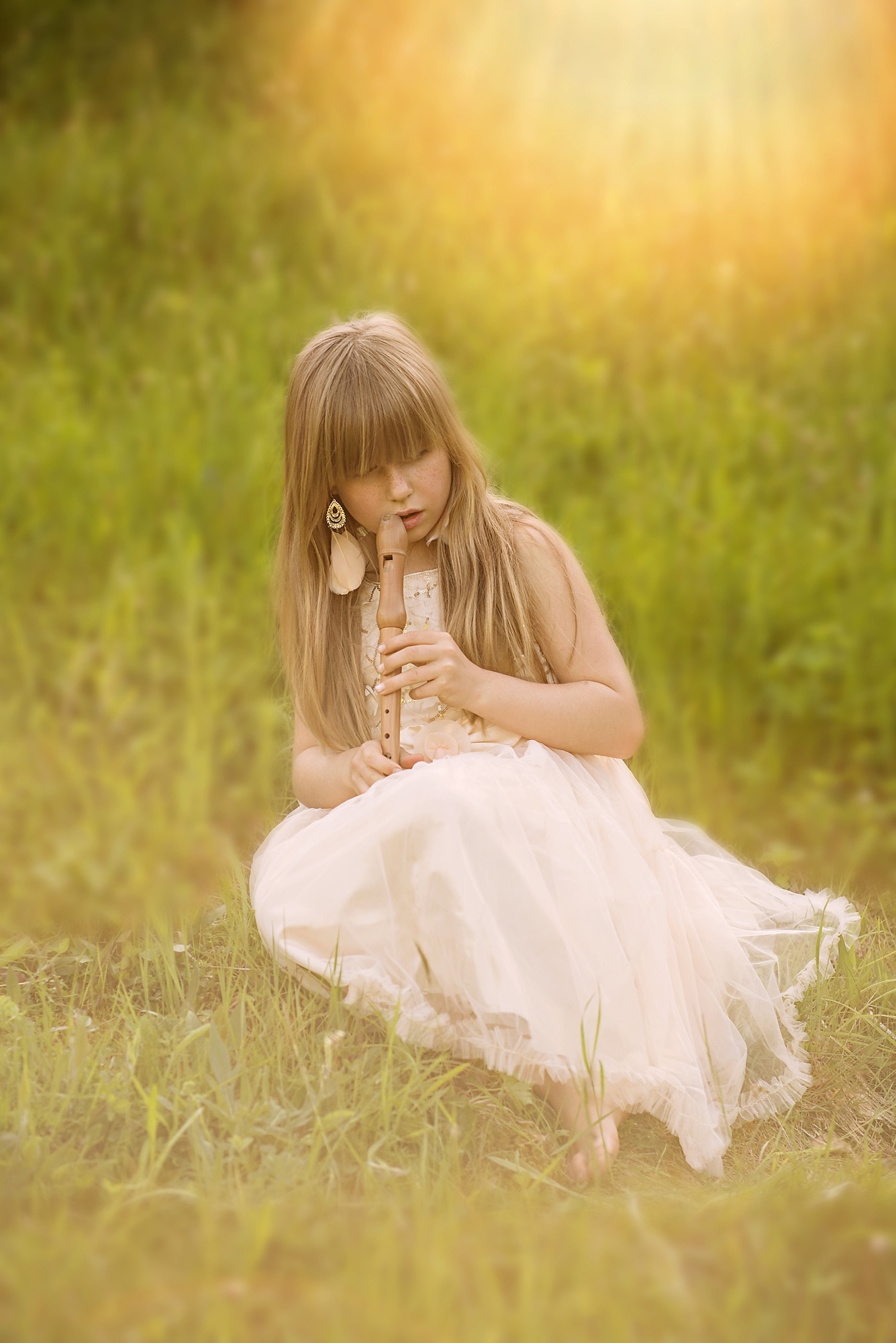 girl's wearing white sleeveless dress using brown clarinet under sunny day during daytime