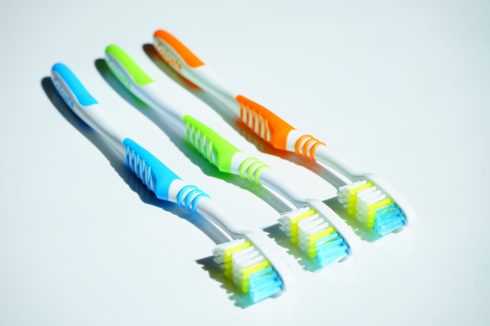 yellow, orange, and blue toothbrushes preview