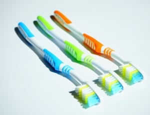 yellow, orange, and blue toothbrushes thumbnail