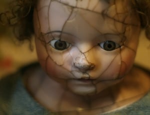 selective photography of a doll in gray crew neck shirt thumbnail