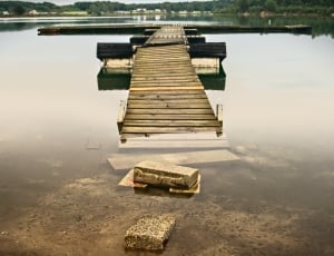 brown wooden beach dock during daytime thumbnail