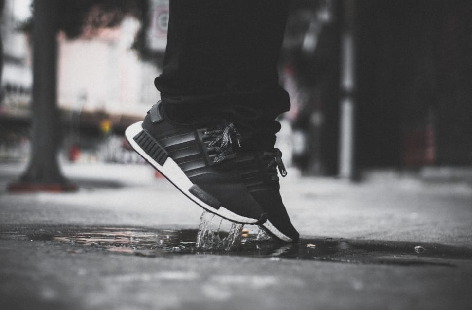 person jumping wearing black-and-white adidas nmd preview