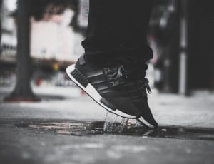 person jumping wearing black-and-white adidas nmd thumbnail