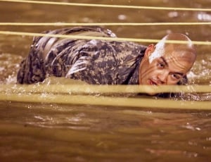 Military crawling in body of water thumbnail