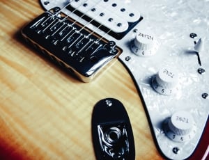 beige and white electric guitar thumbnail