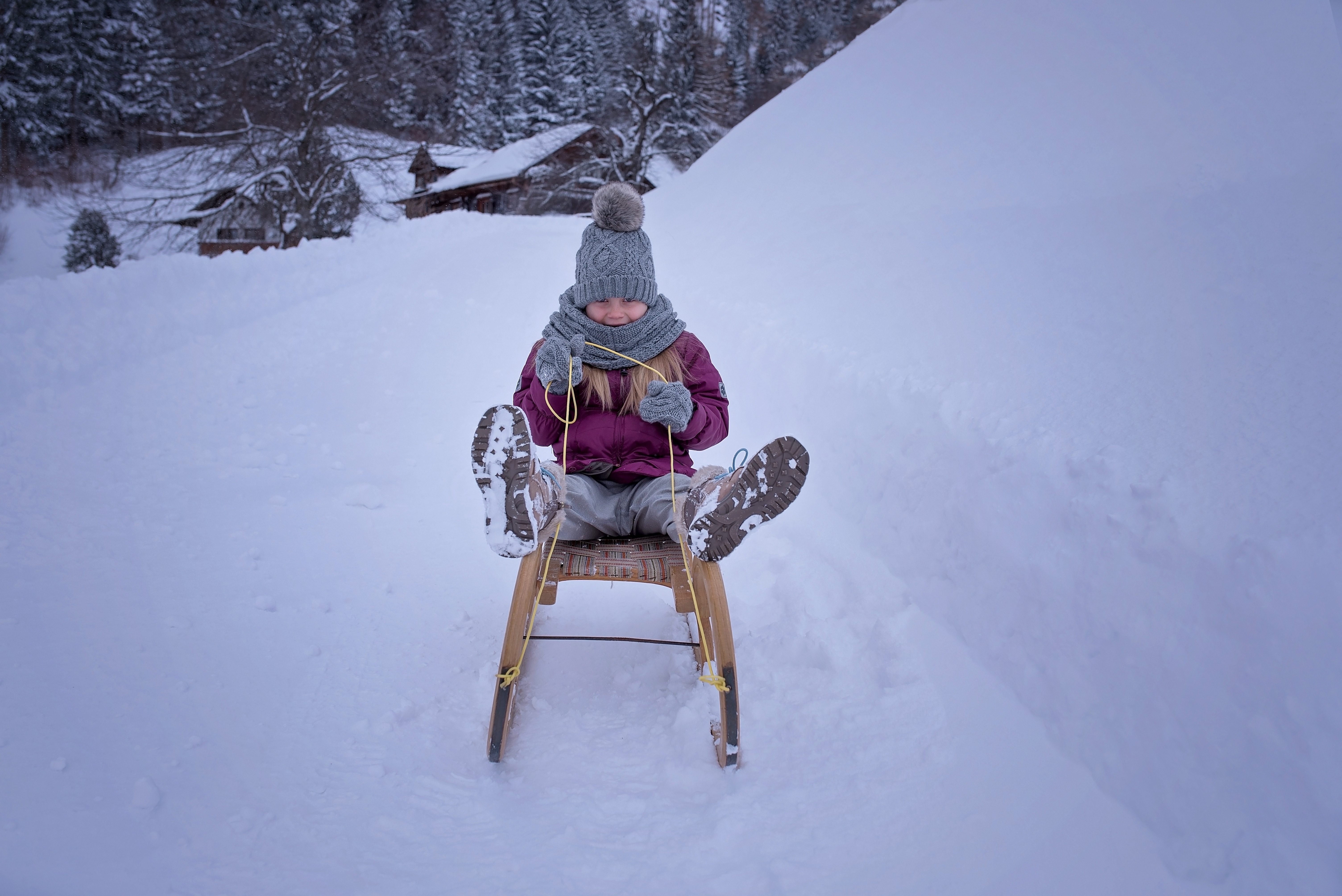 child riding snow sled