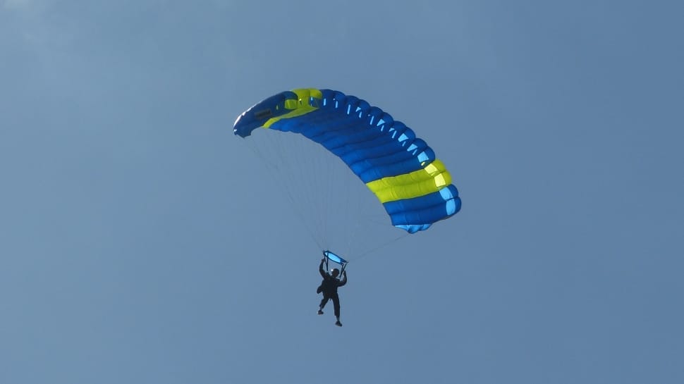 person in blue and yellow parachute preview