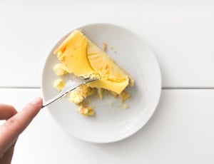 sliced cheesecake on white saucer plate thumbnail
