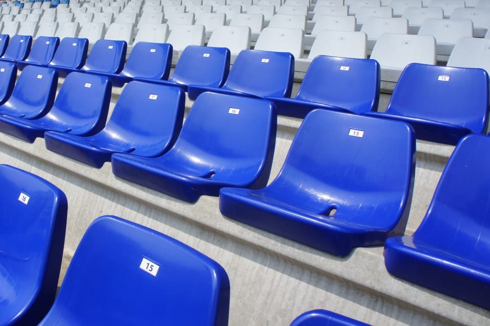 blue and white plastic chairs inside the stadium preview