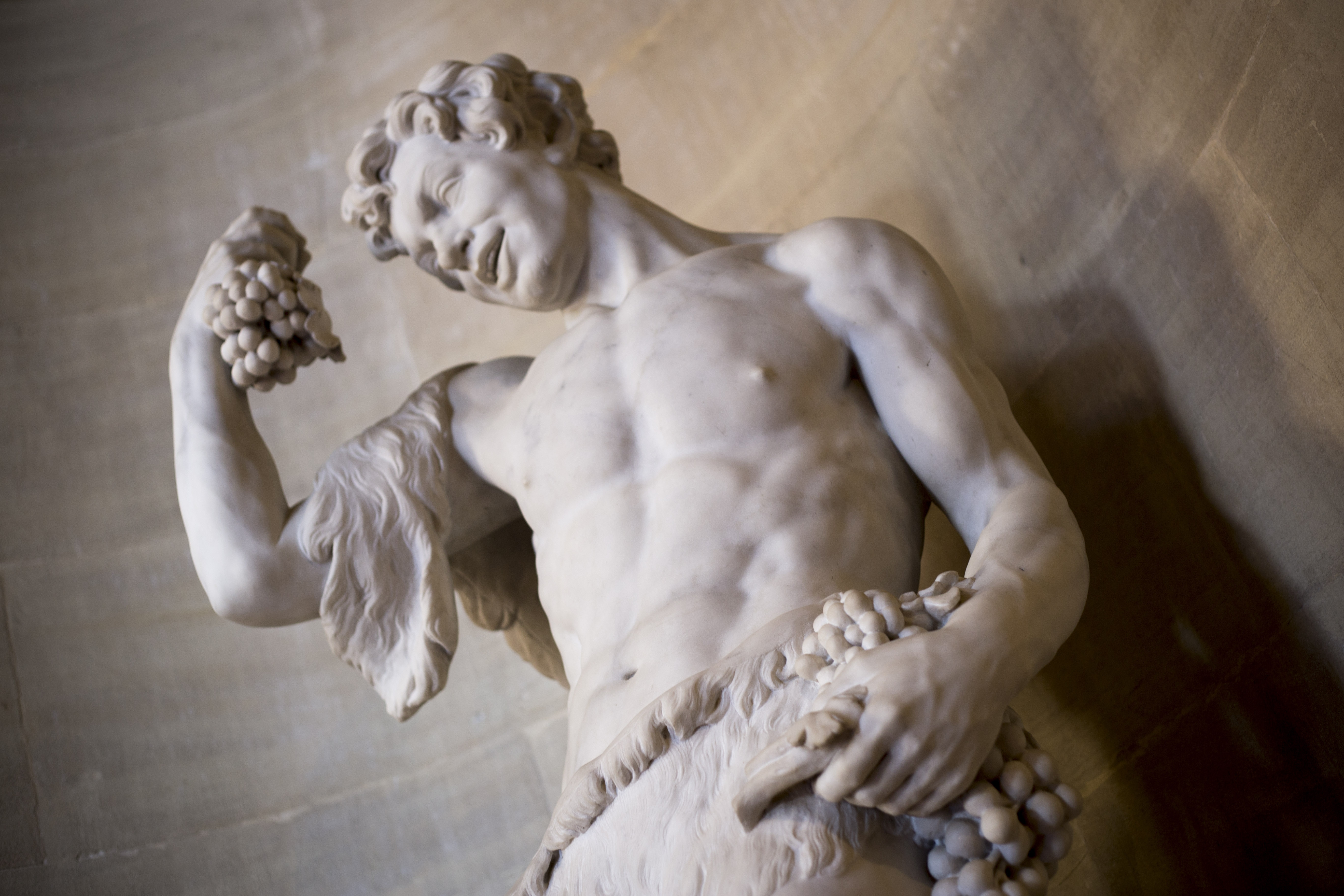 human statue holding grapes