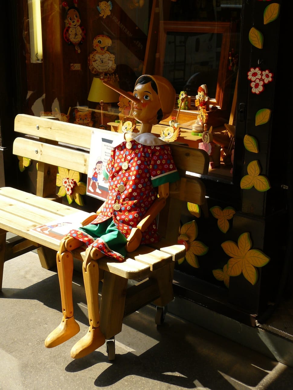 Pinocchio puppet sitting on bench preview