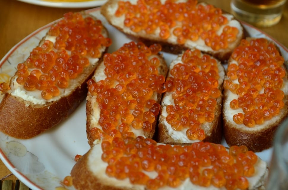six brown and white breads with orange toppings preview