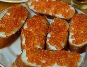 six brown and white breads with orange toppings thumbnail