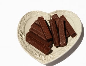 brown chocolate bar on white heart shaped plate thumbnail