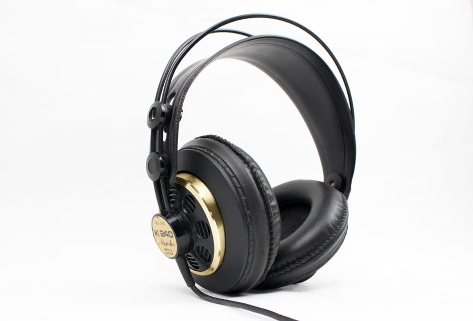 black and brown corded headphones on white surface preview