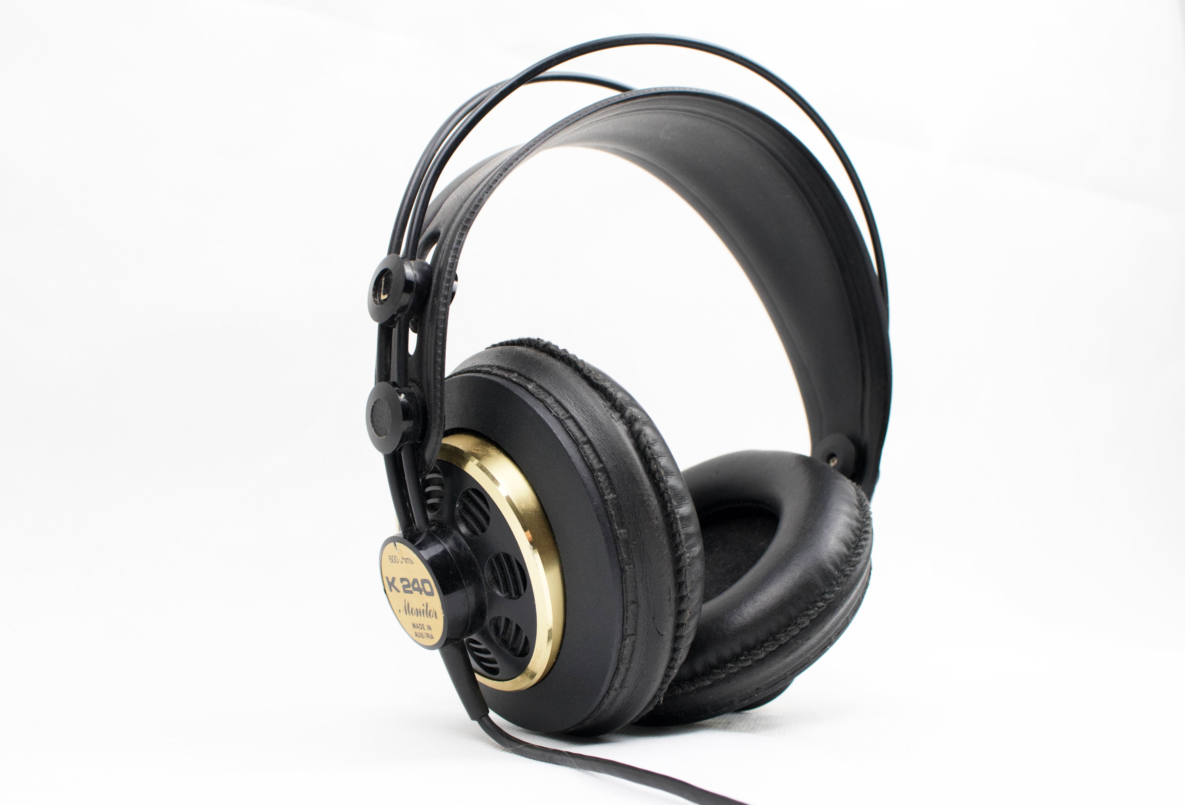 black and brown corded headphones on white surface