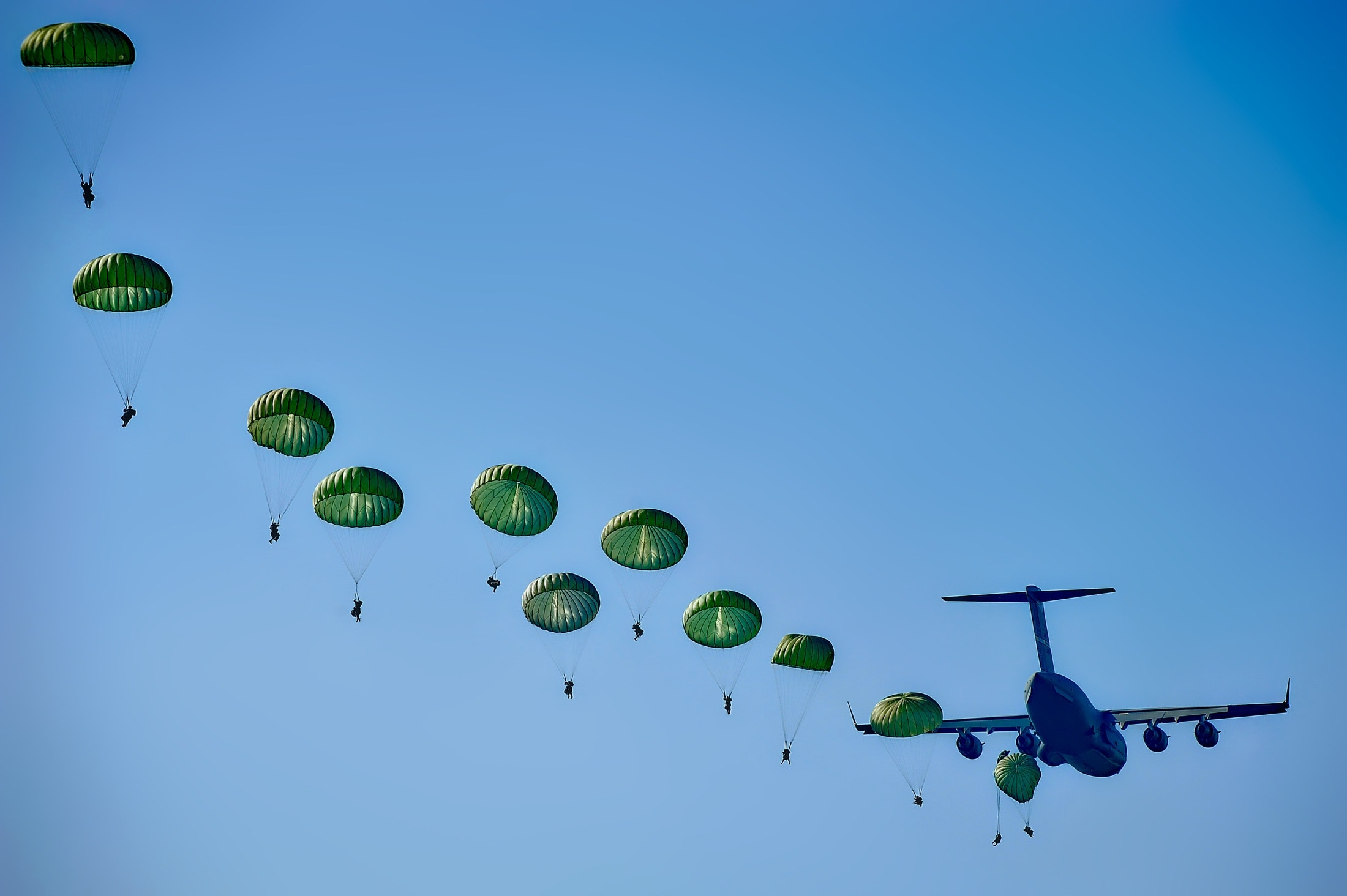 green parachutes and blue airplane