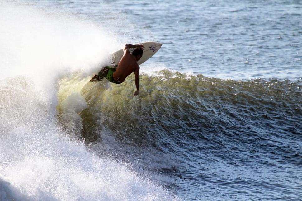 person in green bottoms surfing during daytime preview