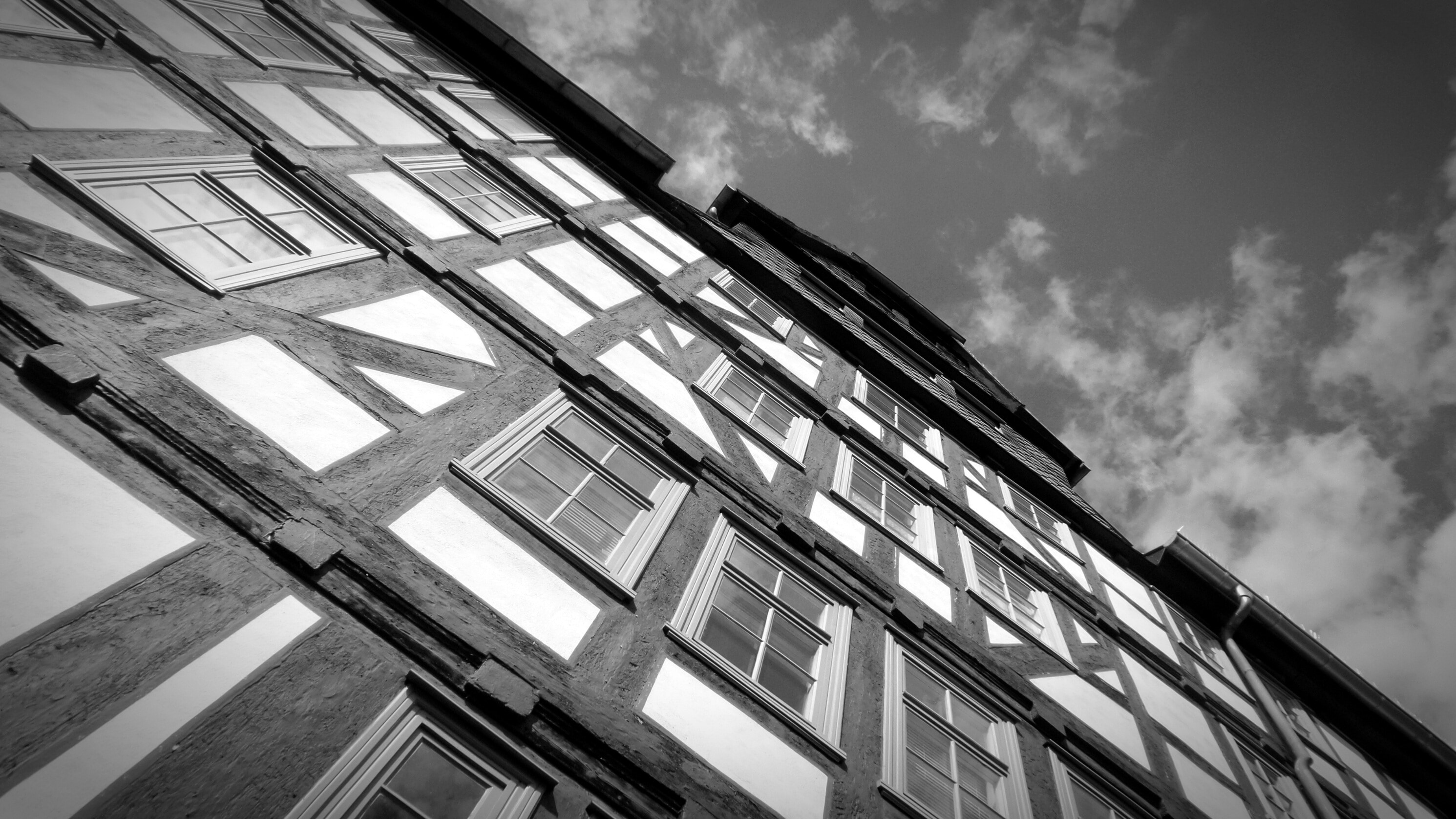 high rise building greyscale photo