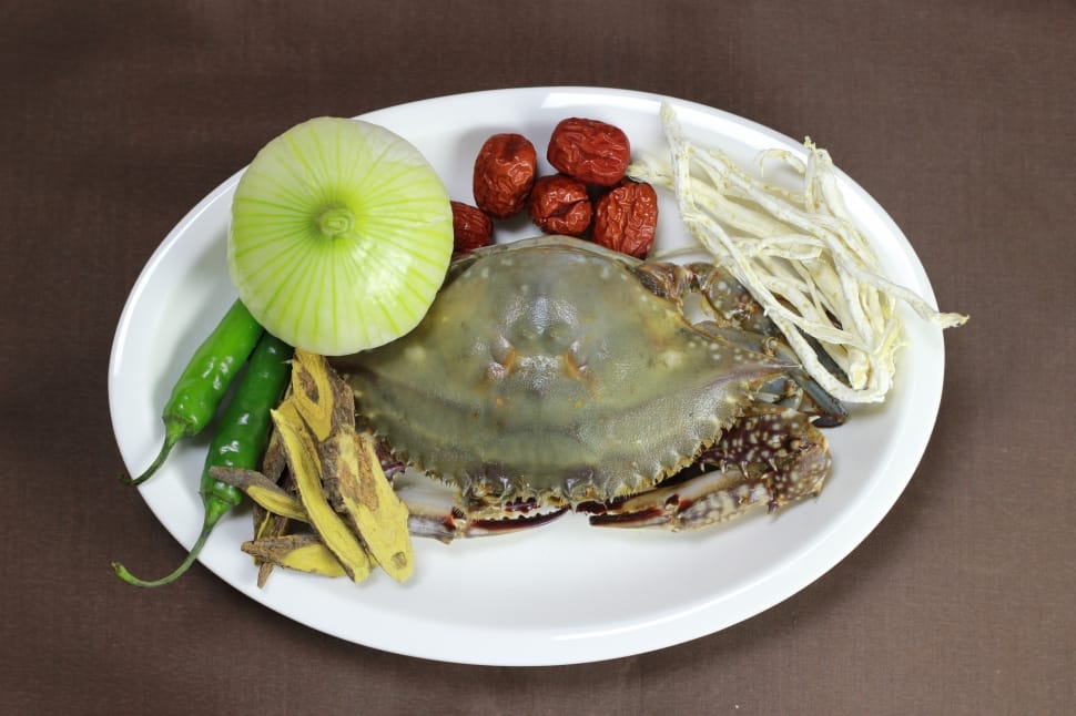 capture image of a raw crab with whole onions two green chillies preview