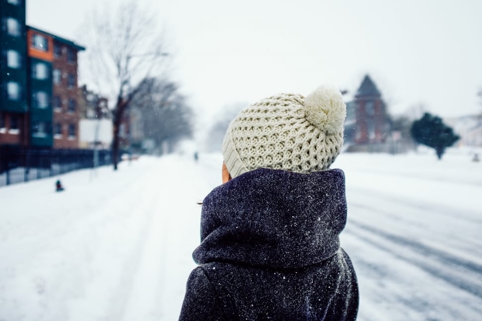 person wearing bobble cap standing in front of snowfield preview