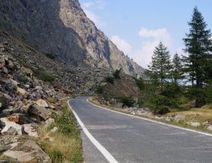 grey concrete road near mountain thumbnail