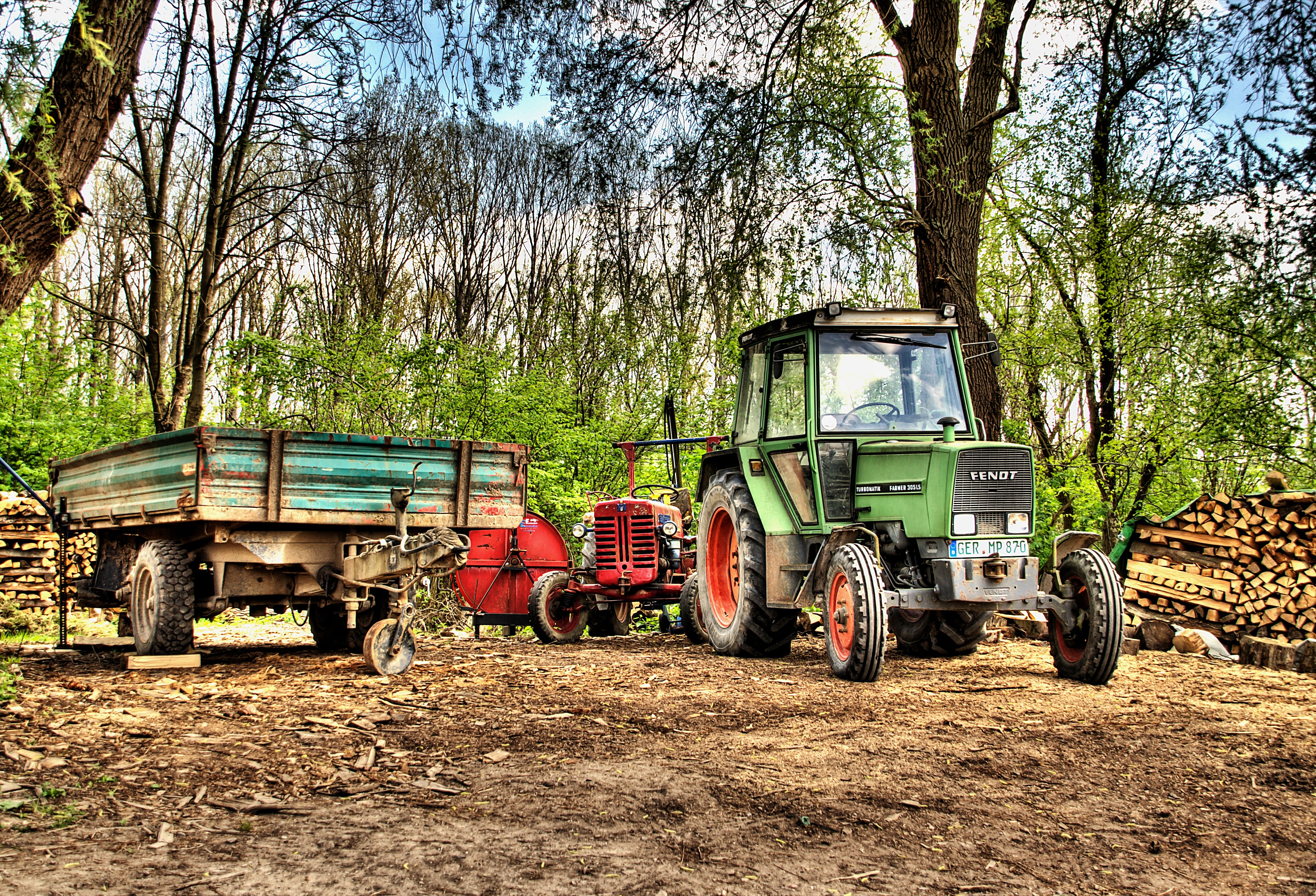 green tractor and utility truck