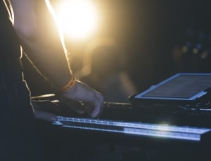 man in front of electric keyboard on stage thumbnail