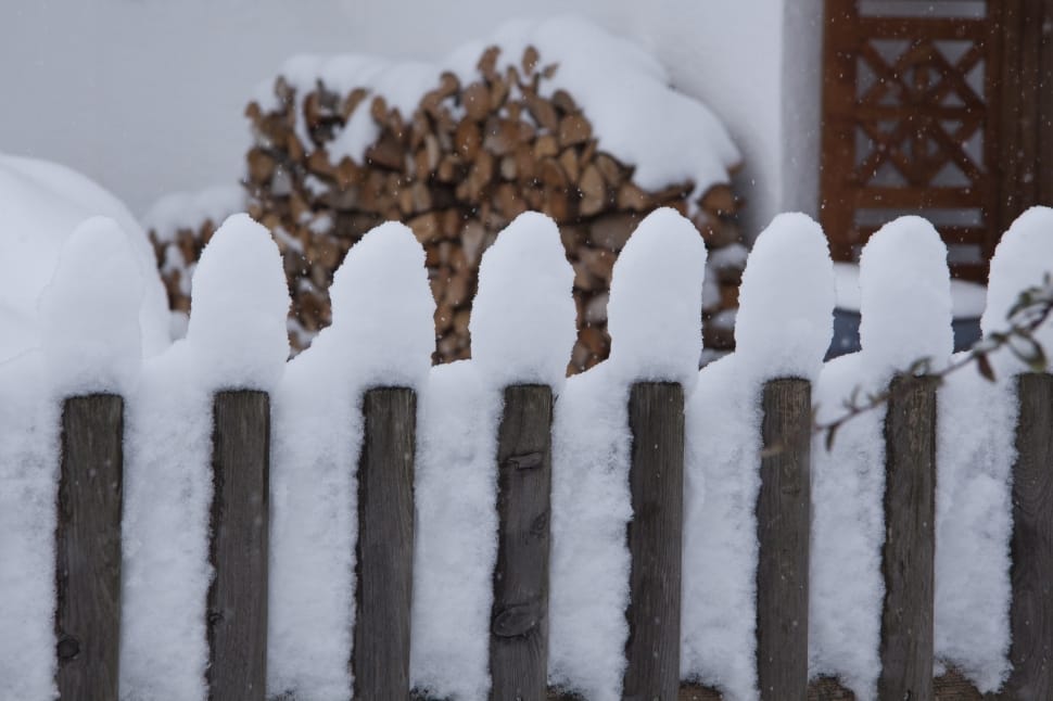 grey wooden fence covered with snow preview