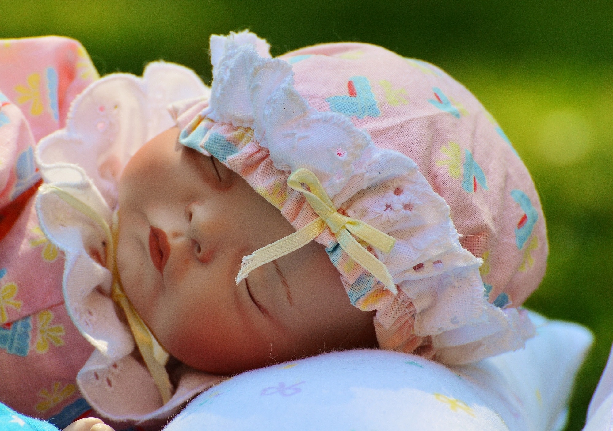 pink teal and beige dressed porcelain baby doll